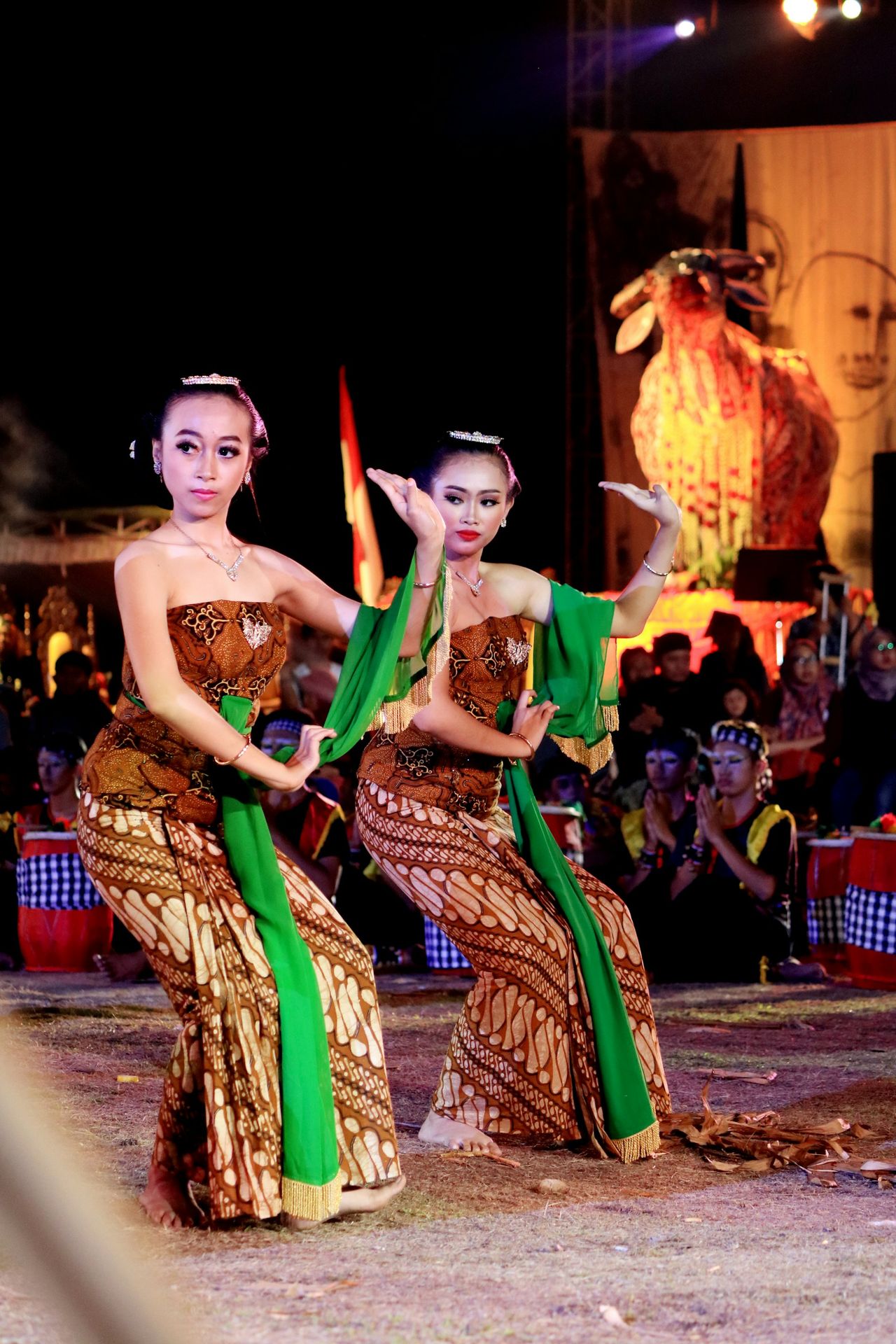 woman in green and yellow dress dancing on street during nighttime